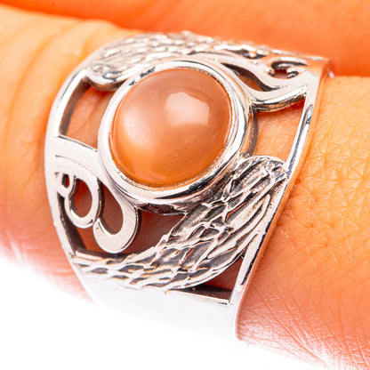 Sterling silver moonstone ring with oval peach cabochon and engraved patterned band
