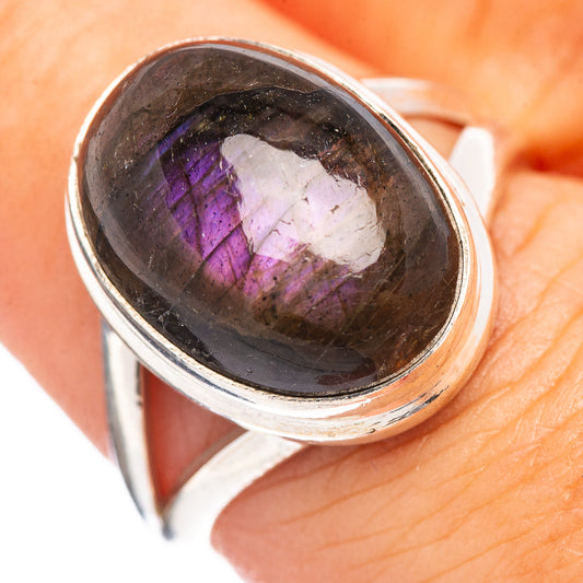 Sterling silver ring with oval labradorite gemstone showing purple-blue flash