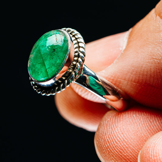 Sterling silver oval green emerald ring, braided detail on band, angled closeup