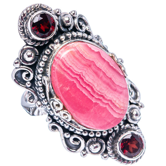 Oval pink rhodochrosite center ring, .925 sterling silver with 3 red garnet stones
