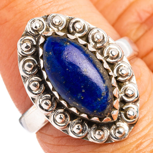 Sterling silver lapis lazuli oval ring with ornate bezel and band, dark blue gemstone