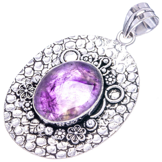 German silver amethyst pendant with oval purple cabochon in textured floral frame and ring bail