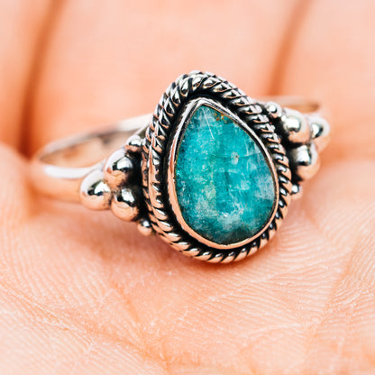 Turquoise-green teardrop stone sterling silver ring with ornate bead and braided band