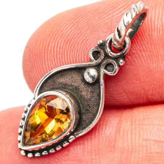 Sterling silver citrine pendant with teardrop bezel and pear-cut yellow gemstone