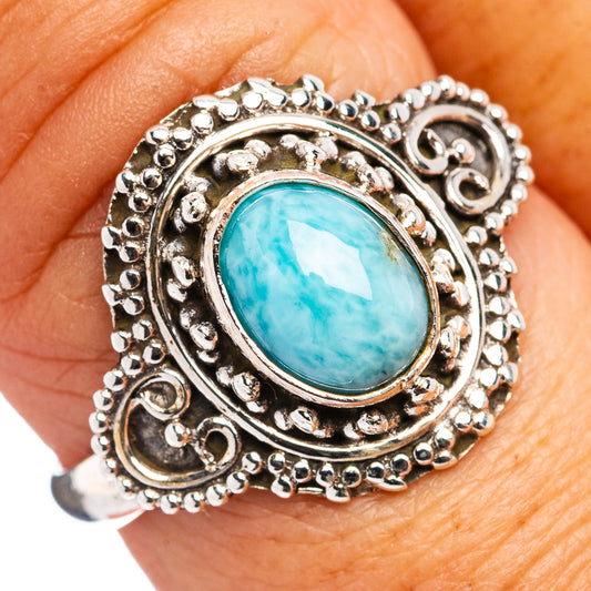Sterling silver Larimar oval bezel ring with ornate beaded border, on finger