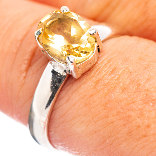 Sterling silver citrine oval ring with faceted yellow gemstone, side angle close-up
