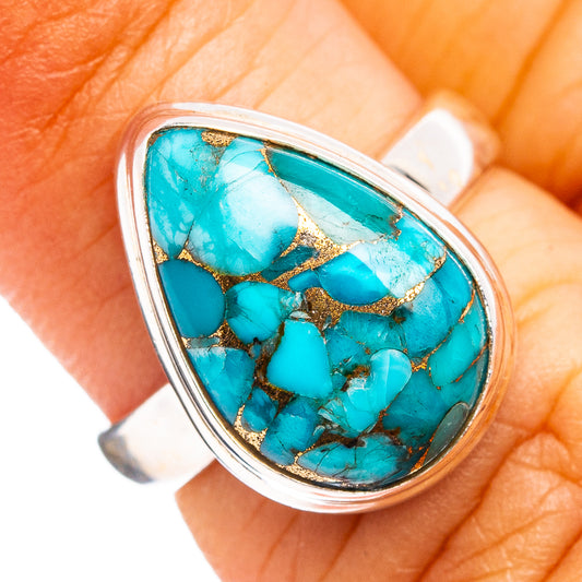 Sterling silver turquoise ring with blue teardrop inlay and gold-toned matrix lines