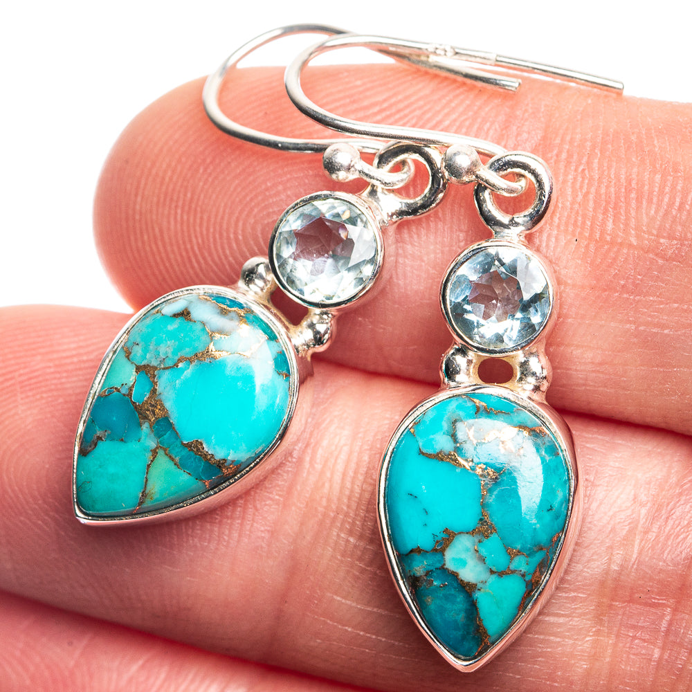 Sterling silver earrings with turquoise teardrop stones and blue round accents