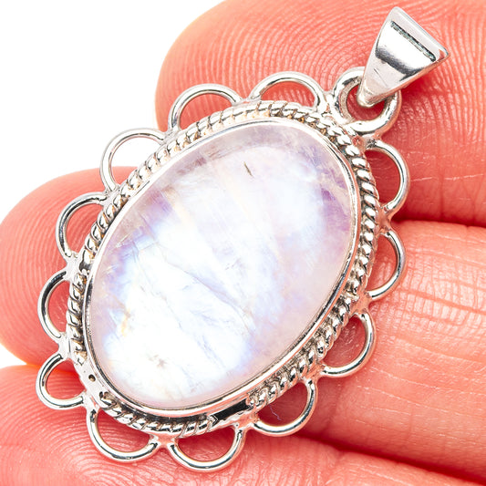 Oval iridescent moonstone pendant in sterling silver with scalloped bezel and looped bail
