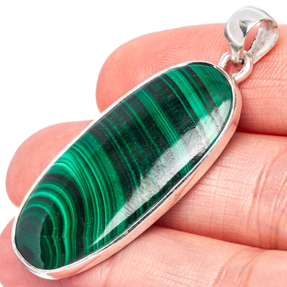 Oval malachite pendant in silver bezel with hinged bail, green and white striped stone