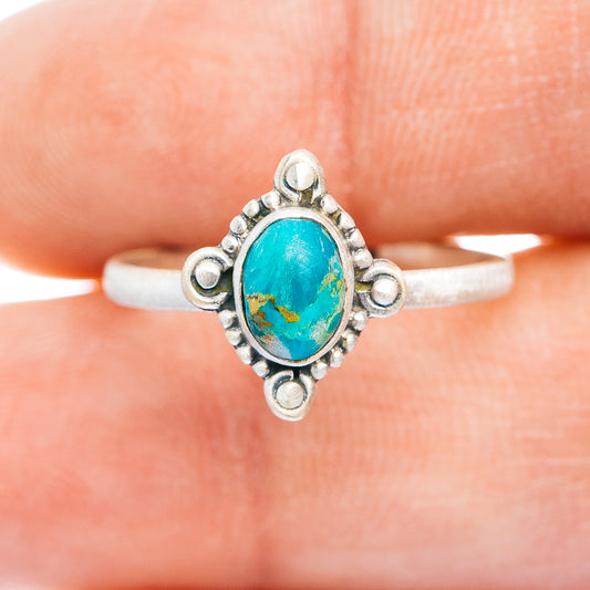 Sterling silver turquoise ring, oval blue cabochon centerpiece with decorative side posts