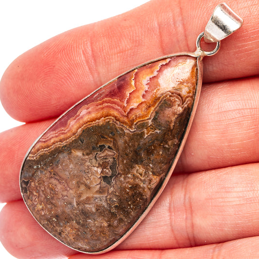 Silver-plated teardrop rhodochrosite pendant with side bail and orange-red striped stone