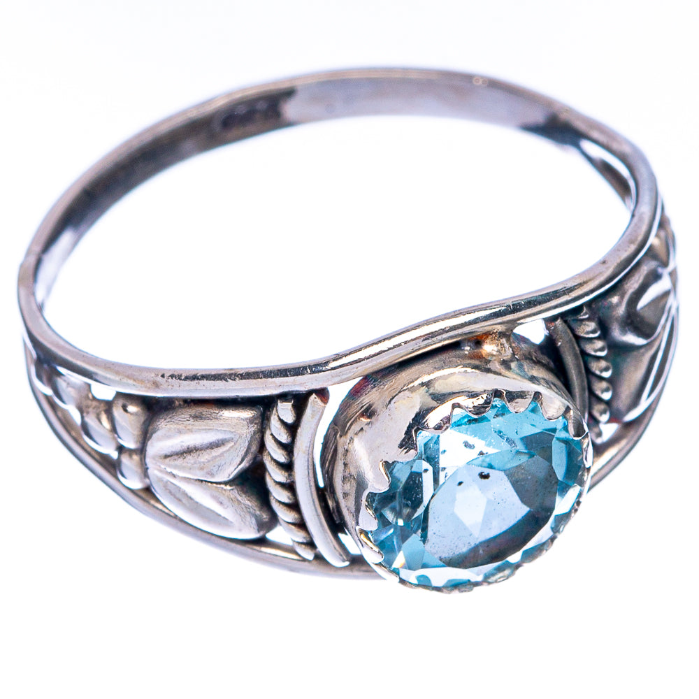 Sterling silver ring band with oval blue topaz and engraved side detailing