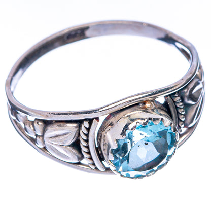 Sterling silver ring band with oval blue topaz and engraved side detailing