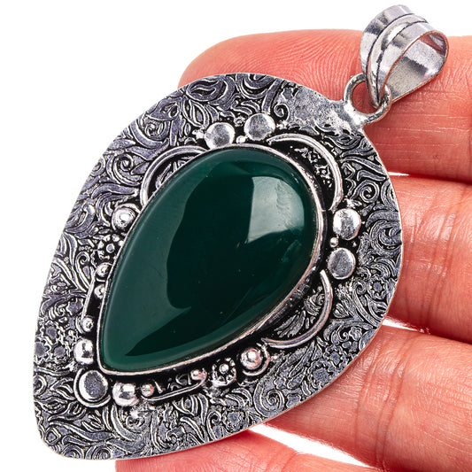 Green onyx teardrop pendant with ornate German silver filigree and loop bail