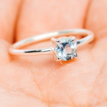 Blue topaz stackable ring with oval prong-set stone and slim silver band