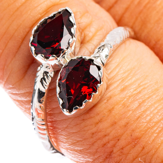 Sterling silver ring with two faceted dark red gemstones, detailed prong settings