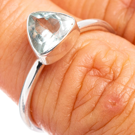 Aquamarine gemstone sterling silver ring with faceted triangular stone, close-up