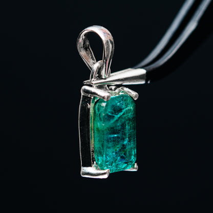 Sterling silver emerald pendant side view with rectangular green faceted stone, prong-set bail