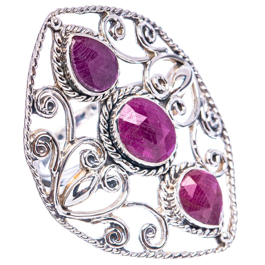 Sterling silver ring with three oval ruby-colored stones and ornate filigree