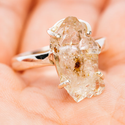 Side view of a sterling silver ring with a large, irregular quartz gemstone