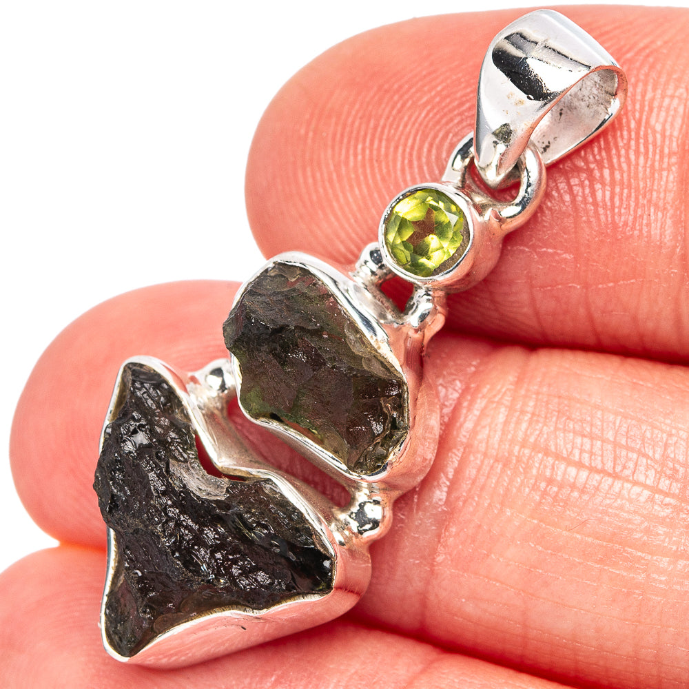 Sterling silver moldavite and peridot pendant with dark rough stone and round green gem