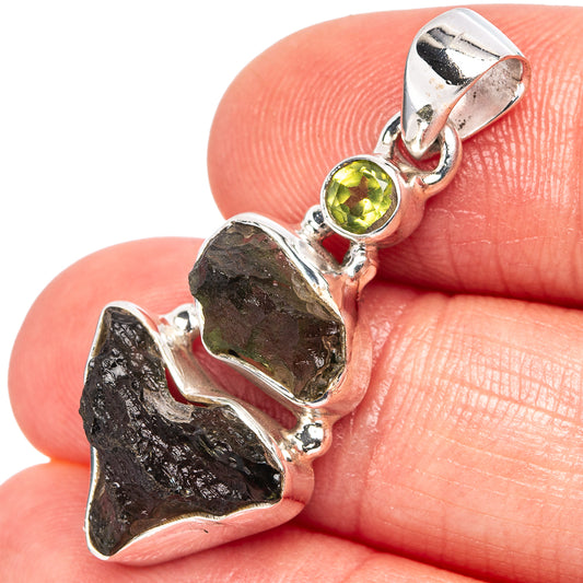 Sterling silver moldavite and peridot pendant with dark rough stone and round green gem