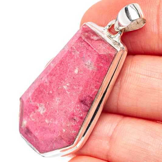 Pink thulite pendant with .925 sterling silver bail and bezel, close-up on stone.