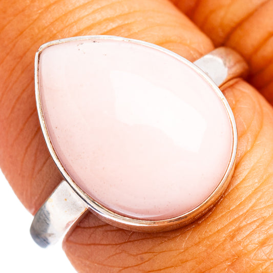 Sterling silver ring with pink oval cabochon opal bezel setting