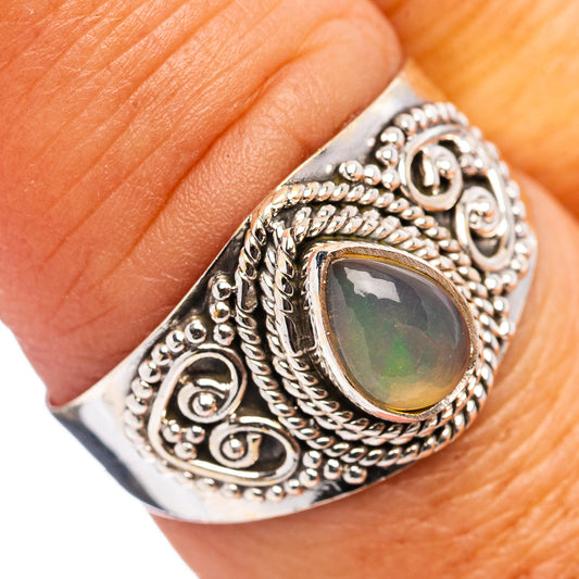 Sterling silver opal ring with oval dark green centerpiece and ornate filigree setting