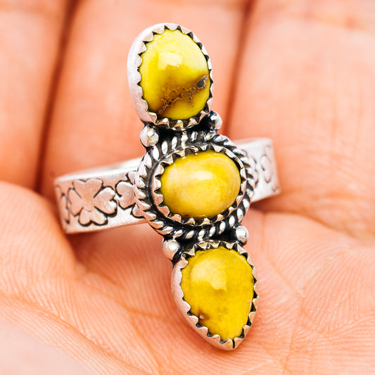 Sterling silver adjustable ring with three oval yellow stones on an etched band