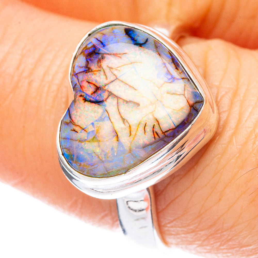 Heart-shaped opal ring, 925 sterling silver, close-up of iridescent blue and gold stone