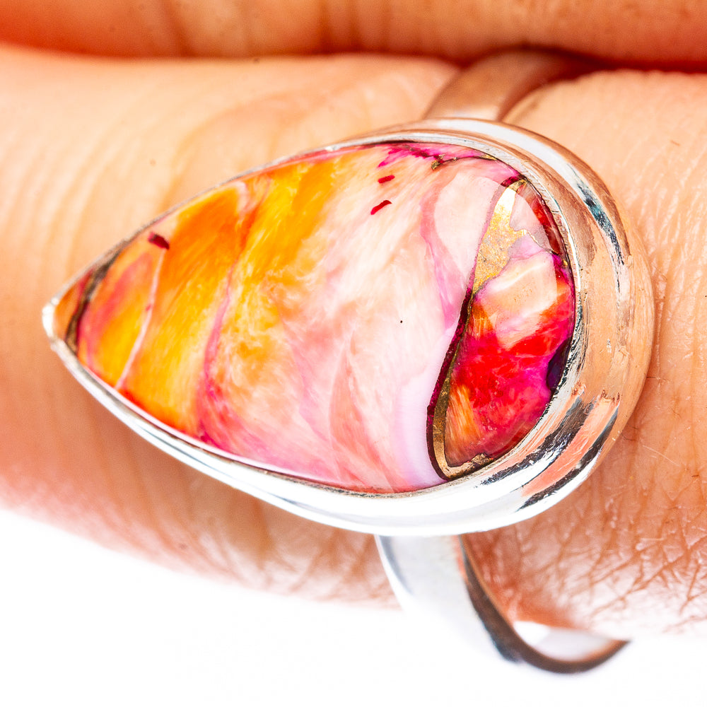 Oval pink-orange cabochon sterling silver ring, side bezel setting detail