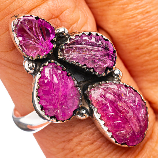 Sterling silver ring with four oval carved pink-purple gemstones, black prong setting