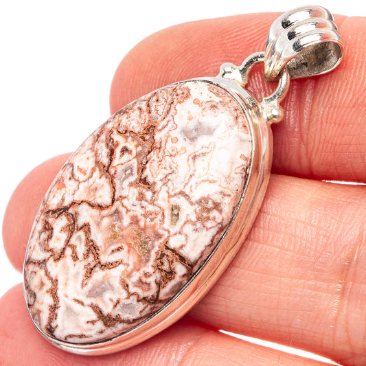 Close-up red-and-white oval jasper pendant in .925 sterling silver with bail