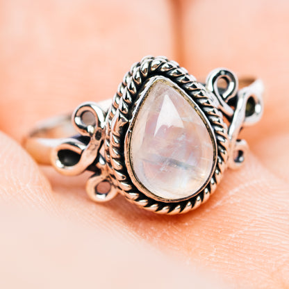 Oval moonstone ring in .925 sterling silver with ornate rope border and dangling loops