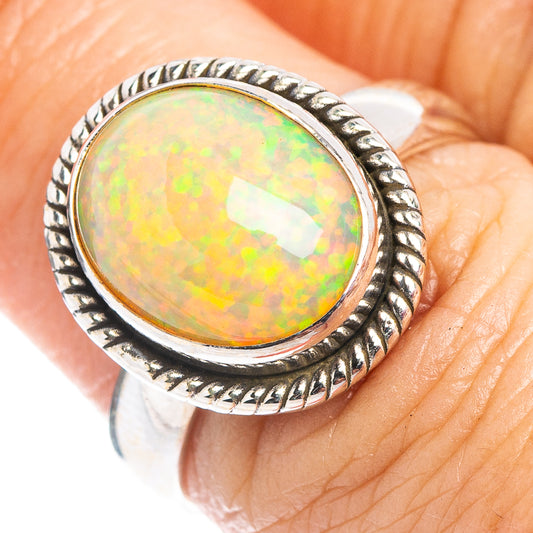 Sterling silver opal ring with oval opal cabochon and rope-style bezel