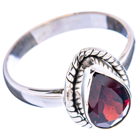 Sterling silver ring with dark red faceted oval stone, rope-like border