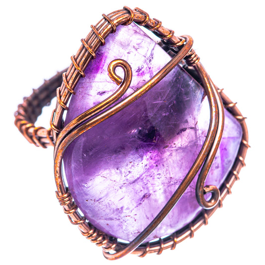 Wire-wrapped amethyst cabochon ring with oxidized copper frame and twisted band