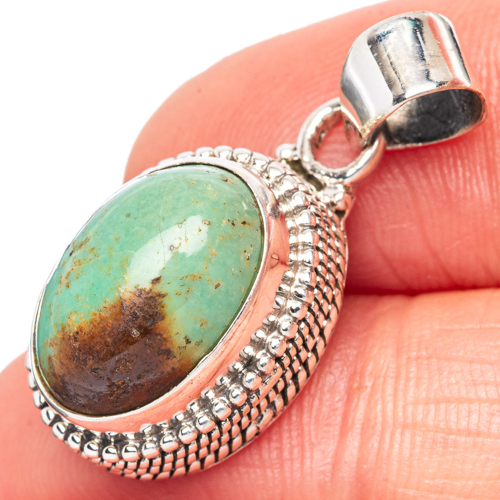 Oval Kingman turquoise cabochon pendant in 925 sterling silver with bail clasp.