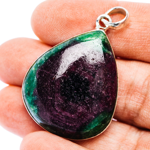 Teardrop gemstone pendant in sterling silver with green edges and purple center.