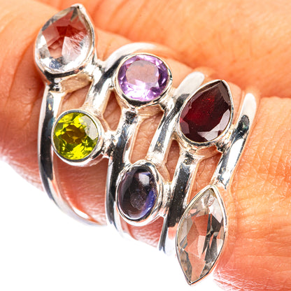 Sterling silver ring with red, purple, yellow, and clear oval gemstones; openwork band