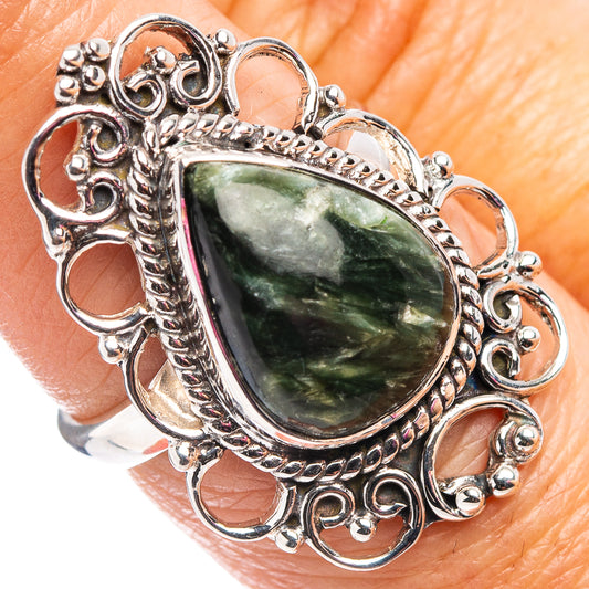 Sterling silver ring featuring a teardrop green seraphinite cabochon in detailed scrollwork
