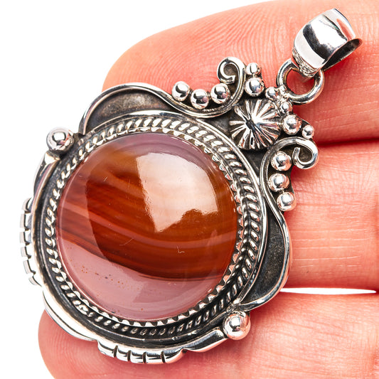 Sterling silver Botswana agate pendant with round amber cabochon and ornate bezel