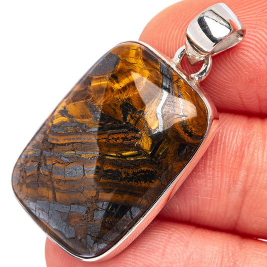 Tiger iron pendant on silver bail, oval stone in orange-brown and blue bands
