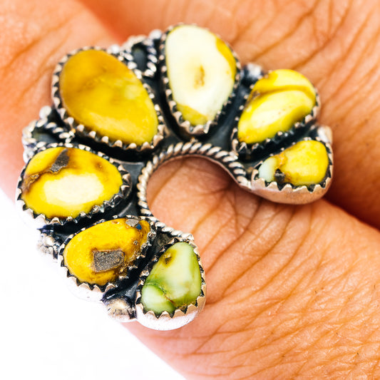 Adjustable sterling silver ring with oval yellow-green stones and black bezel setting