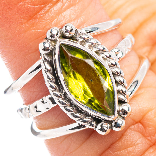 Sterling silver peridot ring with oval green gemstone and ornate bezel setting