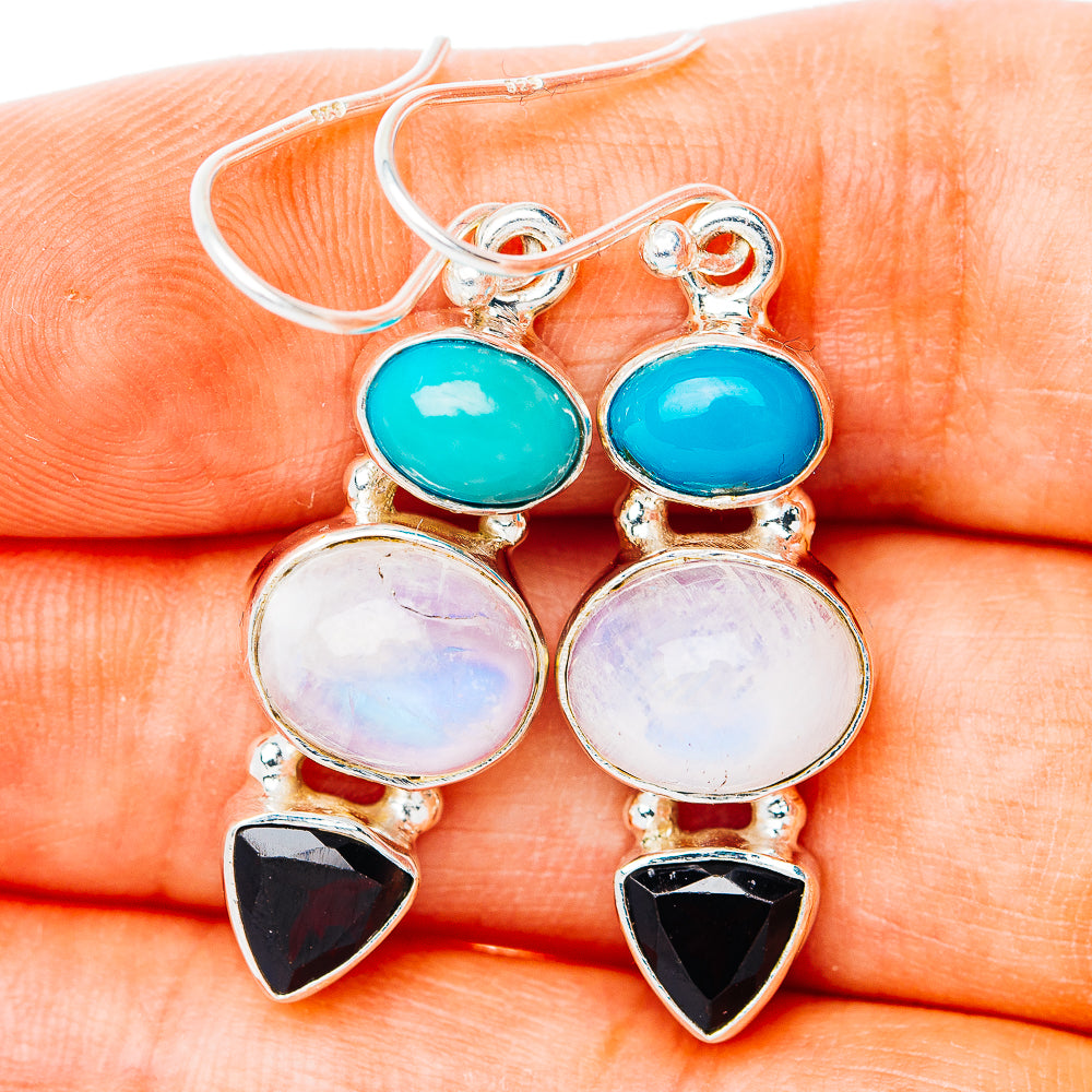 Sterling silver drop earrings with turquoise oval, moonstone discs, and black triangle drops