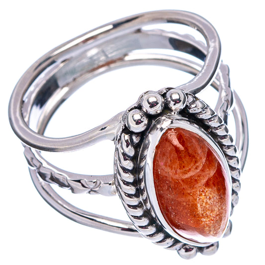 Sterling silver ring with oval orange sunstone and bead-like side detail, open angle view