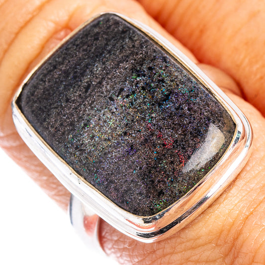 Sterling silver opal ring with dark rectangular bezel and colorful flecks